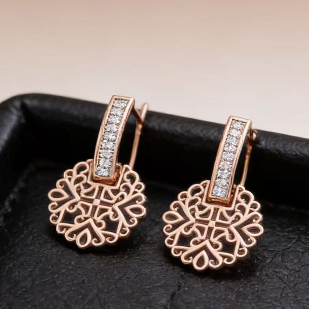 Hollow capsule earrings suspended from a U-line hook.
